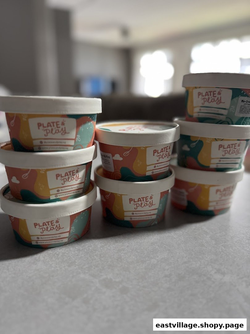 A collection of Plate & Play branded food containers showcasing their product packaging.