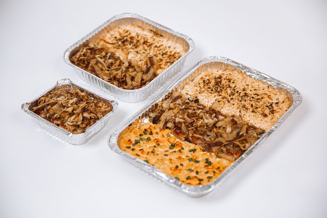 Three foil containers showcasing different delicious food preparations, likely rice dishes with various toppings.