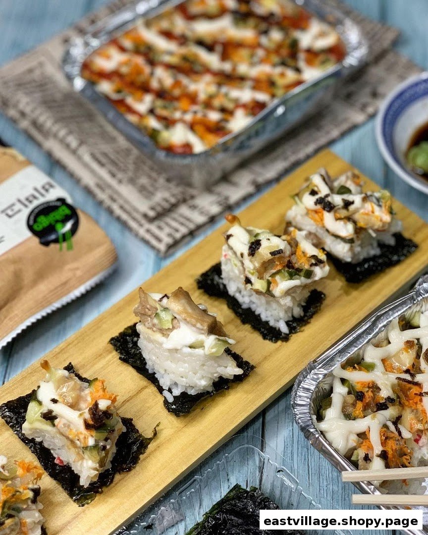 A vibrant display of sushi-style bites and a baked rice dish from RaisuGood.