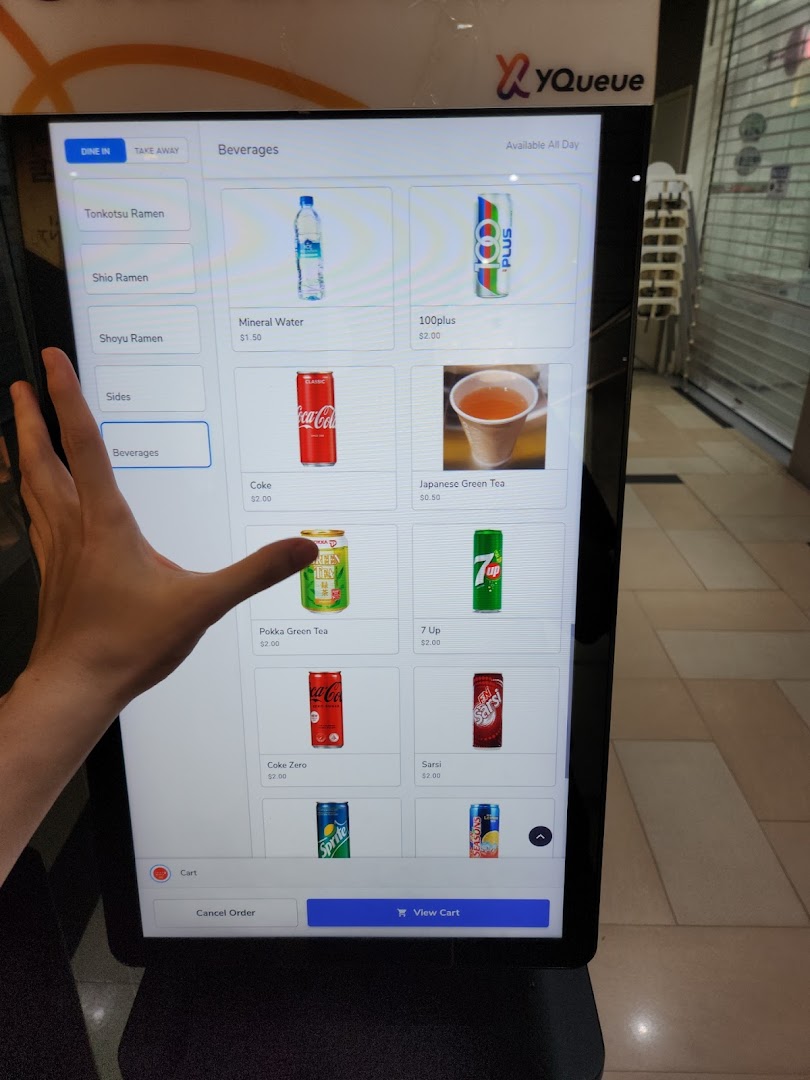 A digital self-ordering kiosk displaying beverage options for a ramen shop.