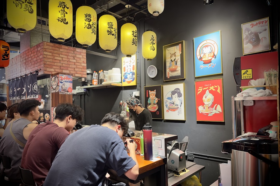 Customers enjoy authentic ramen at a vibrant, counter-style Japanese eatery.