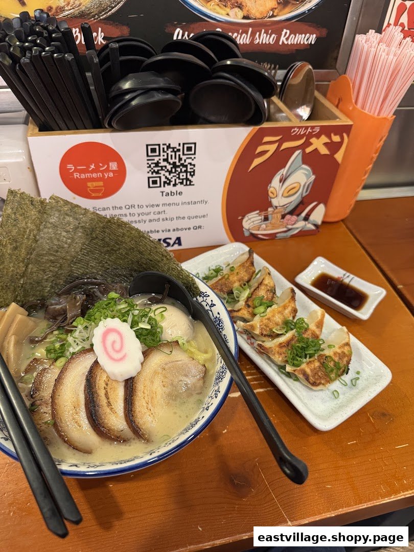 A delicious bowl of ramen and gyoza on a table, with a QR code for convenient ordering.