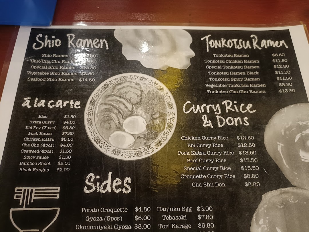 A detailed menu displaying various ramen, curry rice, and side dishes with prices.
