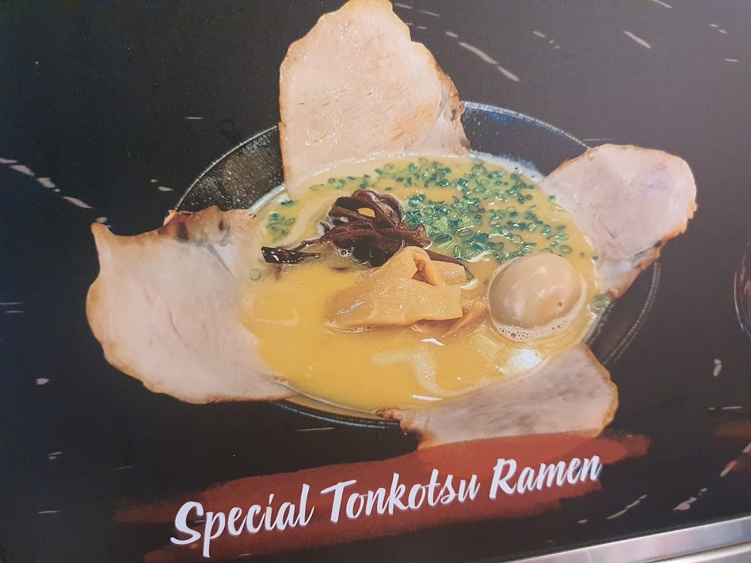 A close-up of a rich Special Tonkotsu Ramen bowl with pork, egg, and various toppings.
