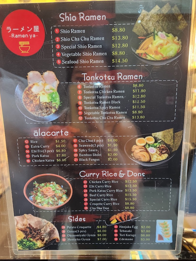 A detailed menu board for Ramen-ya, showcasing various ramen, curry, and side dishes.