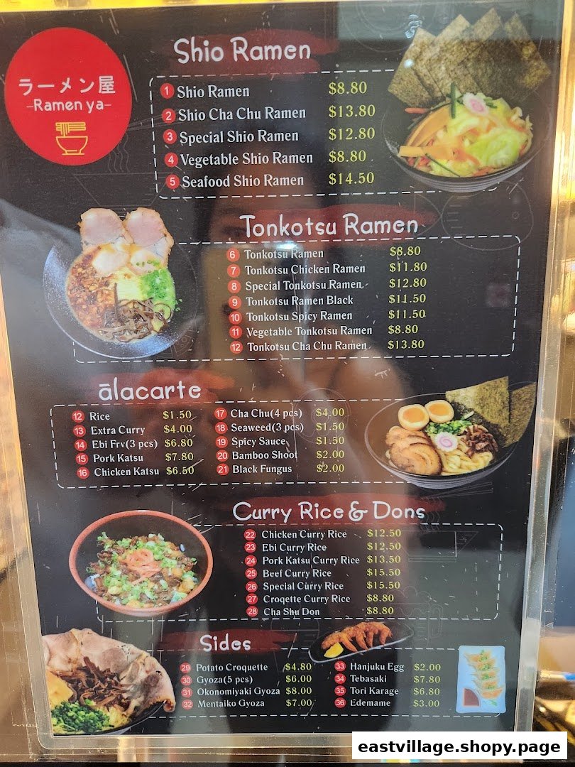 A detailed menu board for Ramen-ya, showcasing various ramen, curry, and side dishes.