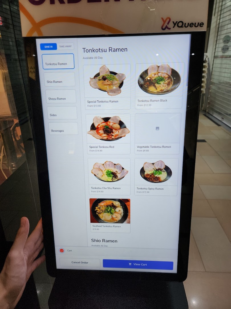 A digital self-order kiosk displaying various ramen dishes and prices.