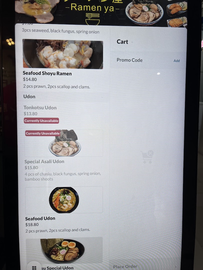 A digital menu display showing various ramen and udon dishes with prices and descriptions.
