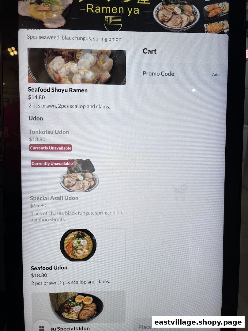A digital menu display showing various ramen and udon dishes with prices and descriptions.
