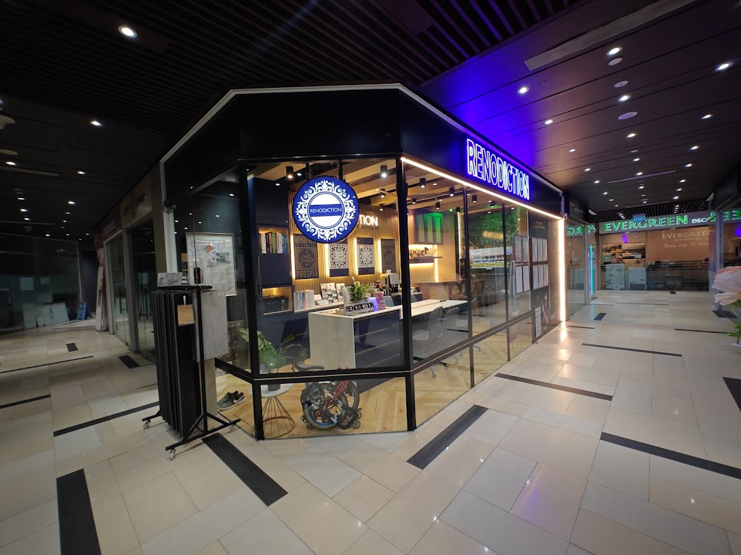 The modern glass-fronted shop RENODICTION PTE. LTD. with a prominent blue neon sign in a mall corridor.