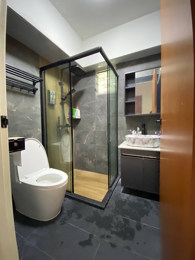 A modern bathroom featuring a glass shower enclosure, sleek vanity, and smart toilet.
