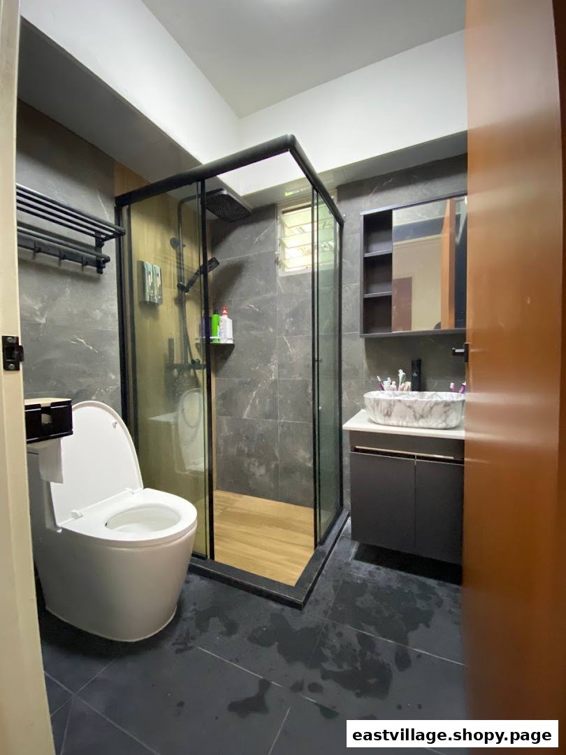 A modern bathroom featuring a glass shower enclosure, sleek vanity, and smart toilet.