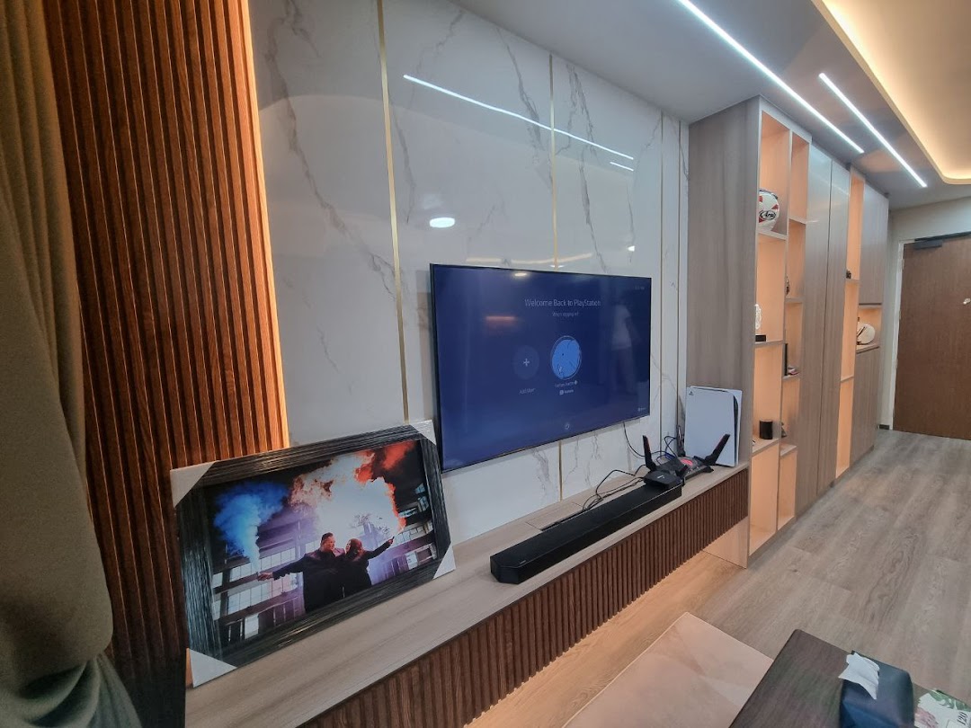 A modern living room setup featuring a large TV, soundbar, gaming console, and custom built-in cabinetry.