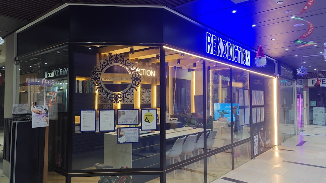 The brightly lit exterior of RENODICTION PTE. LTD., showcasing its modern design and interior.