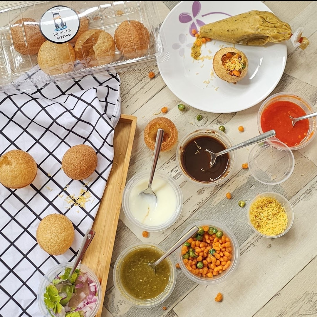 A top-down view of pani puri ingredients, including puris, chutneys, and fillings, ready for assembly.