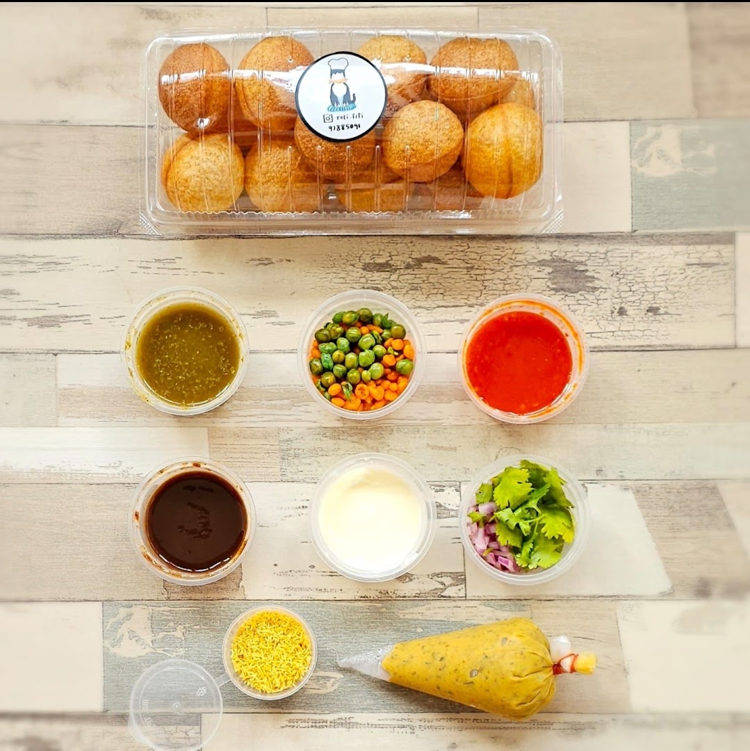 A DIY kit for Pani Puri, featuring crispy shells, various sauces, and fresh toppings.