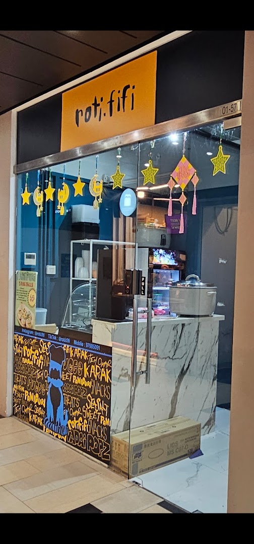 The shop front of Rotififi, featuring a glass entrance, a marble counter, and festive star and moon decorations.