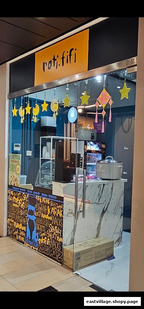 The shop front of Rotififi, featuring a glass entrance, a marble counter, and festive star and moon decorations.