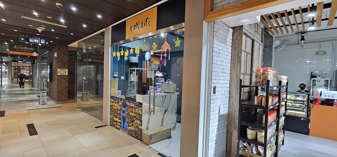 The brightly decorated shop front of ROTIFIFI, a snack and dessert shop, within a bustling mall corridor.