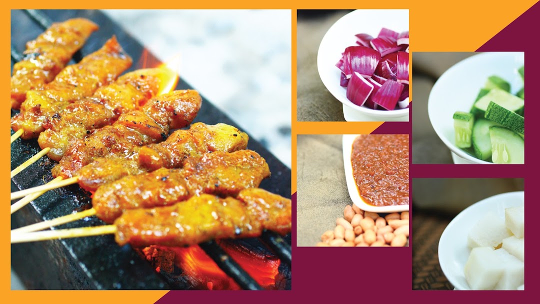 Delicious satay skewers grilling with traditional accompaniments like peanut sauce, onions, cucumbers, and rice cakes.