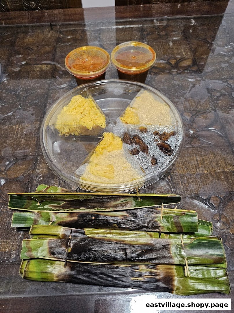 A close-up of various delicious Malaysian dishes, including grilled Otak-Otak and assorted desserts with sauces.