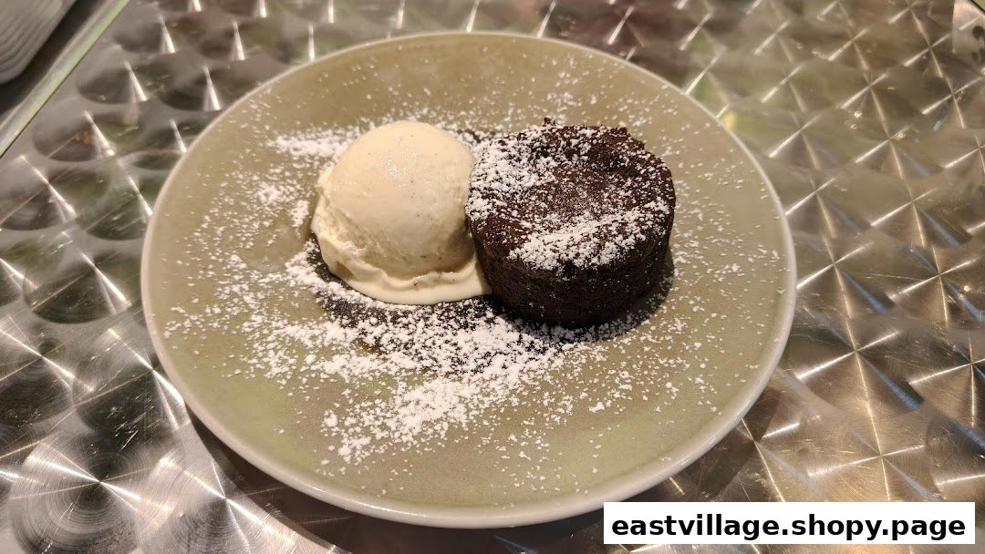 A delicious chocolate lava cake with a scoop of vanilla ice cream, dusted with powdered sugar.