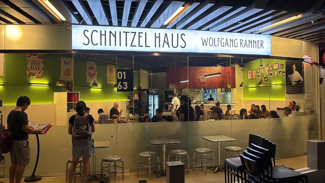 The brightly lit entrance of Schnitzel Haus Wolfgang Ranner, showing customers dining inside.