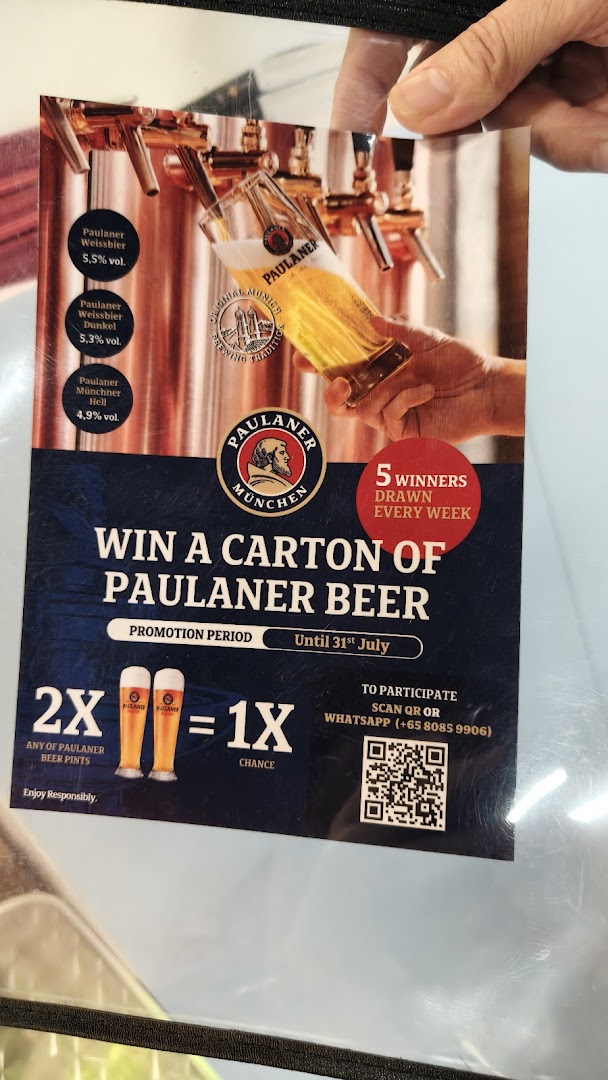 A promotional poster for Paulaner beer, detailing a contest to win a carton of beer.