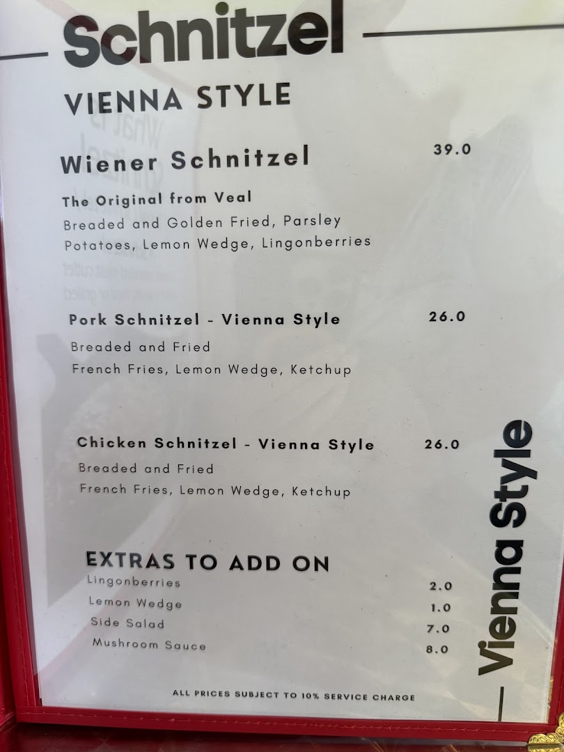 A close-up view of the 'Vienna Style' schnitzel menu, detailing various schnitzel options and add-ons.