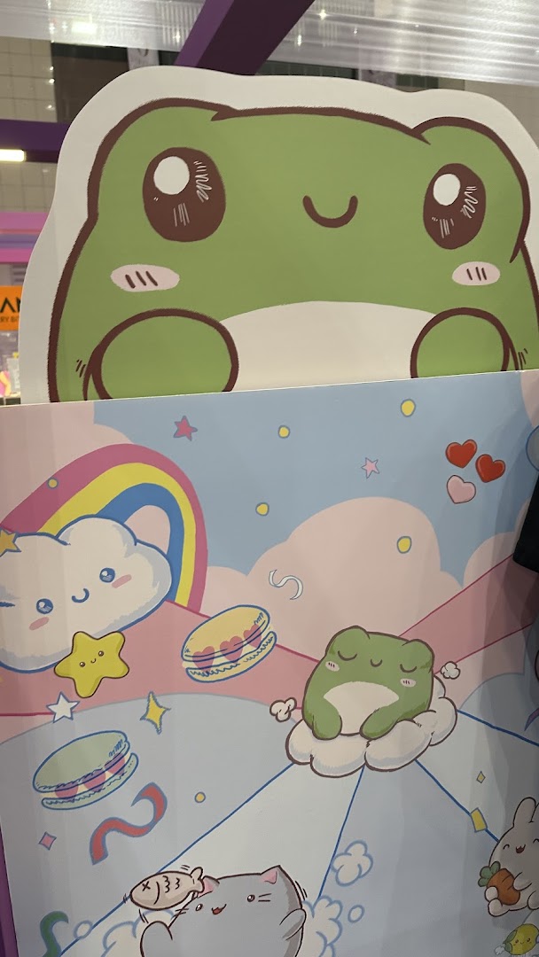 A colorful display featuring cute cartoon frogs, clouds, macarons, and other whimsical characters.