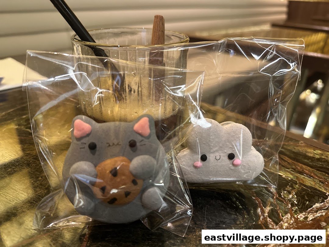 Adorable cat and cloud-shaped treats alongside a refreshing drink, showcasing Sugarsmith's delightful creations.