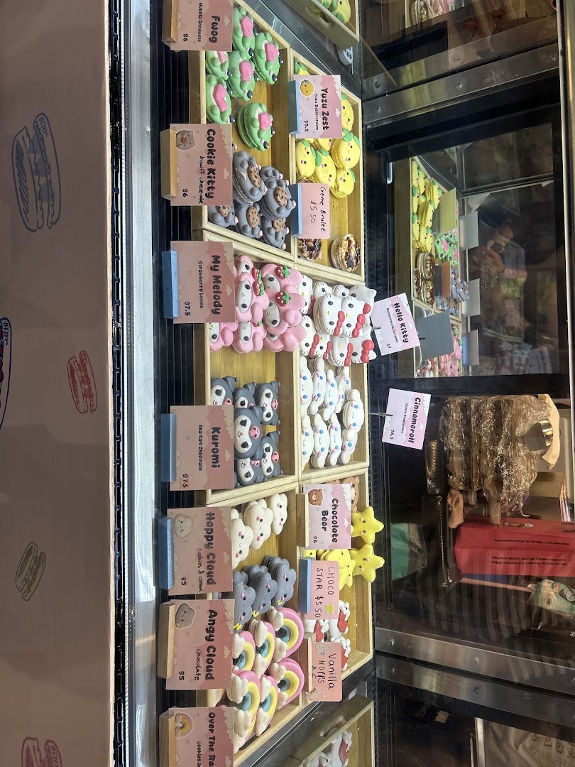 A vibrant display case showcasing an array of character-themed macarons and delightful desserts at Sugarsmith.