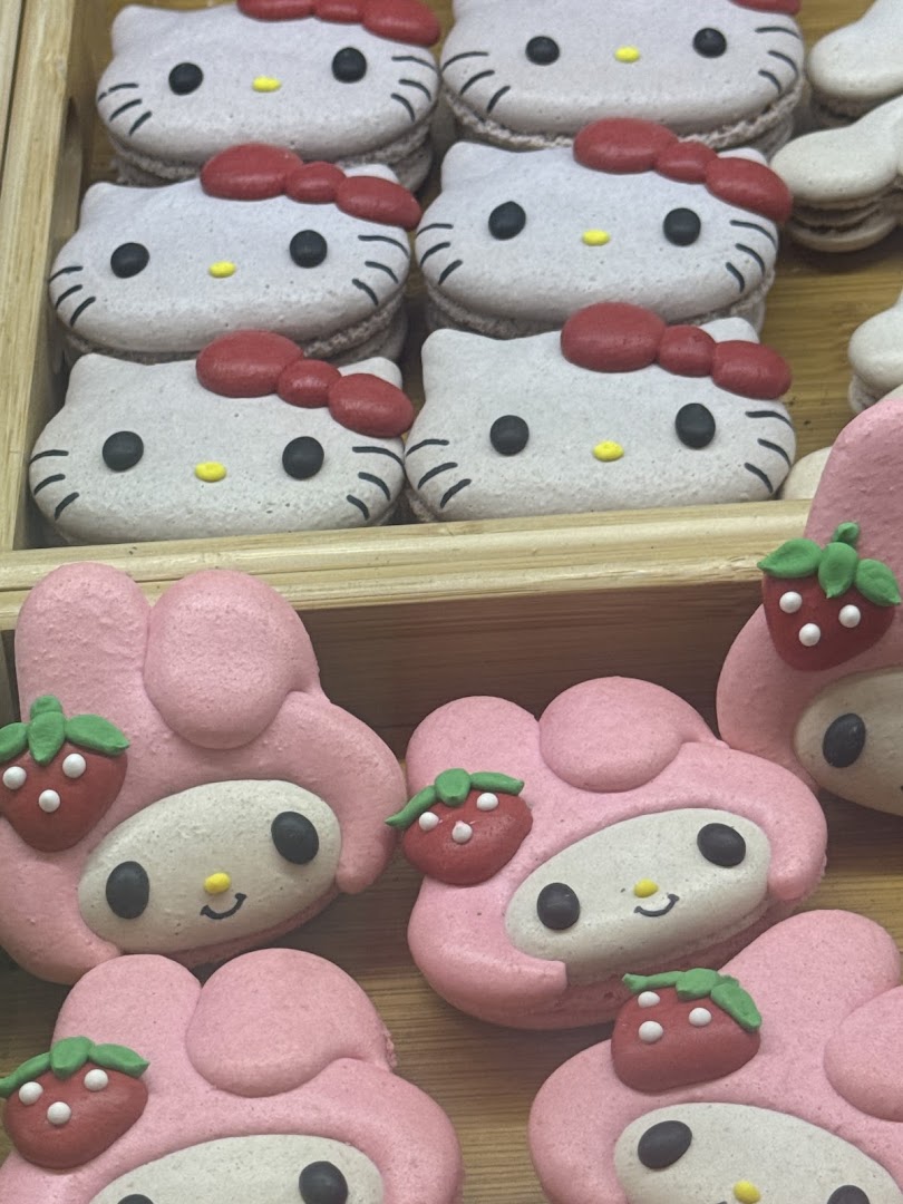 Close-up of adorable Hello Kitty and My Melody character macarons in a display.