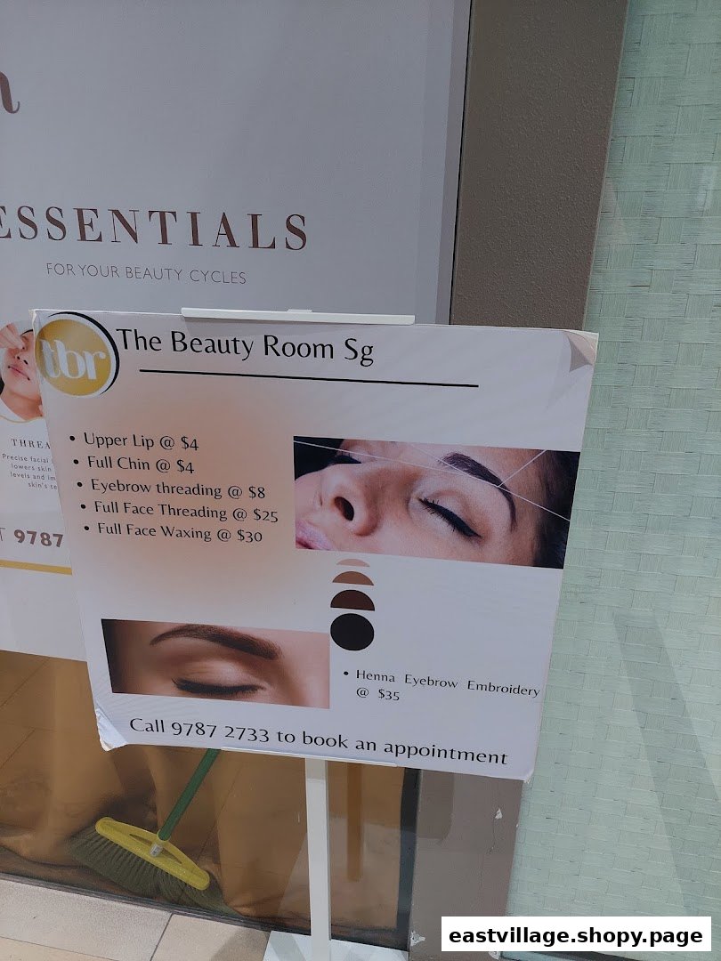 A promotional sign for The Beauty Room Sg, displaying beauty services and their prices.
