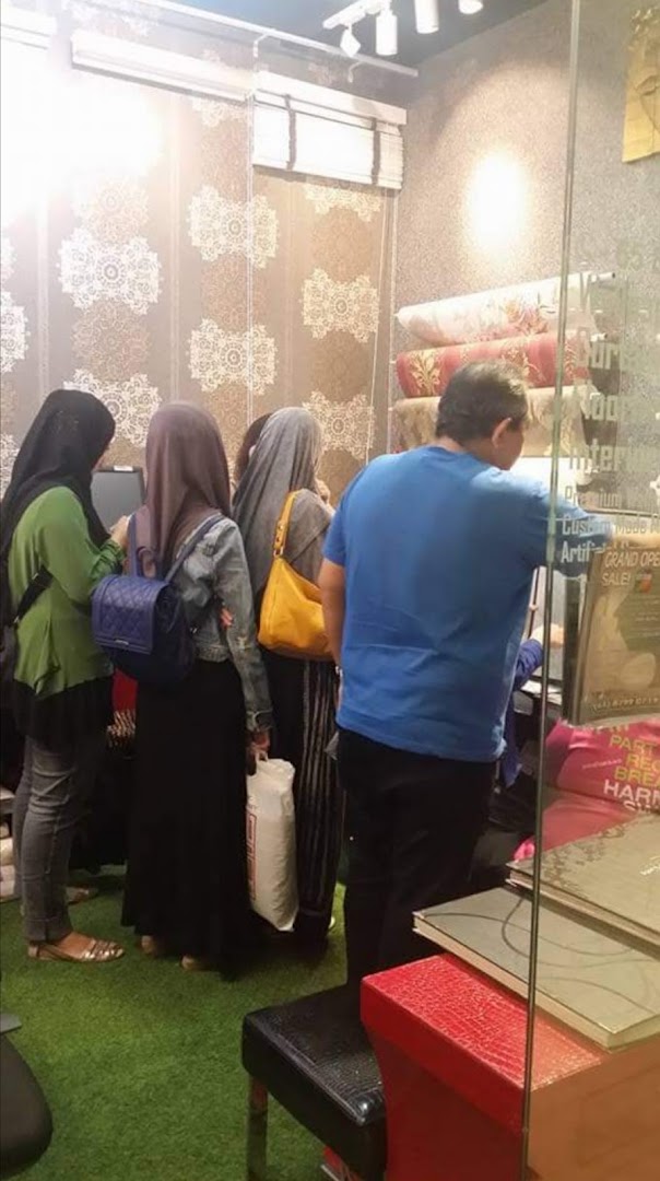 Customers browse wallpaper and curtain samples inside The Catalogue Wallpaper Curtains Gallery.