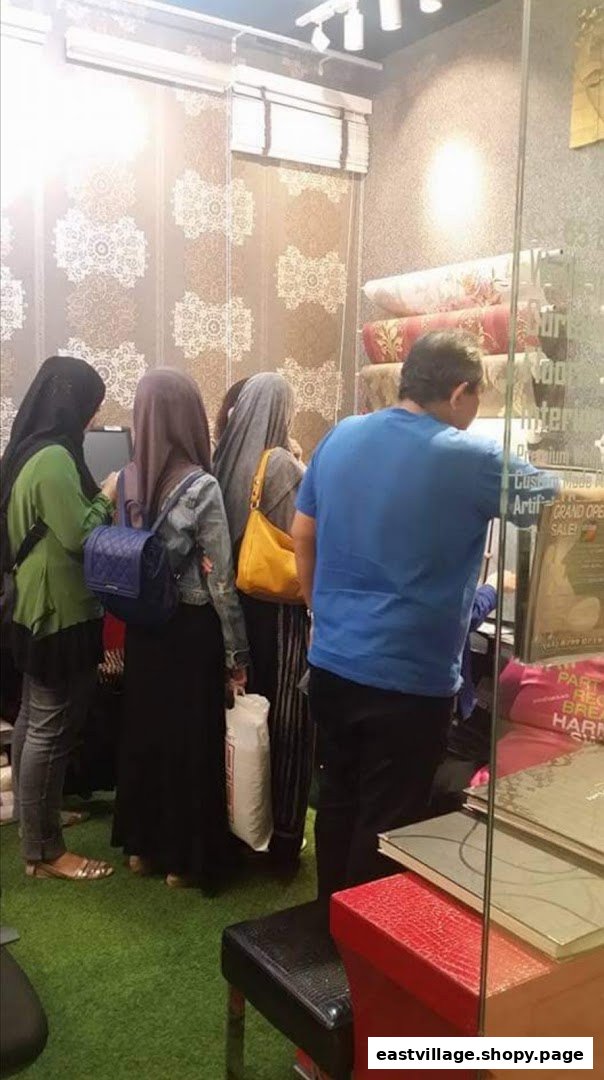 Customers browse wallpaper and curtain samples inside The Catalogue Wallpaper Curtains Gallery.