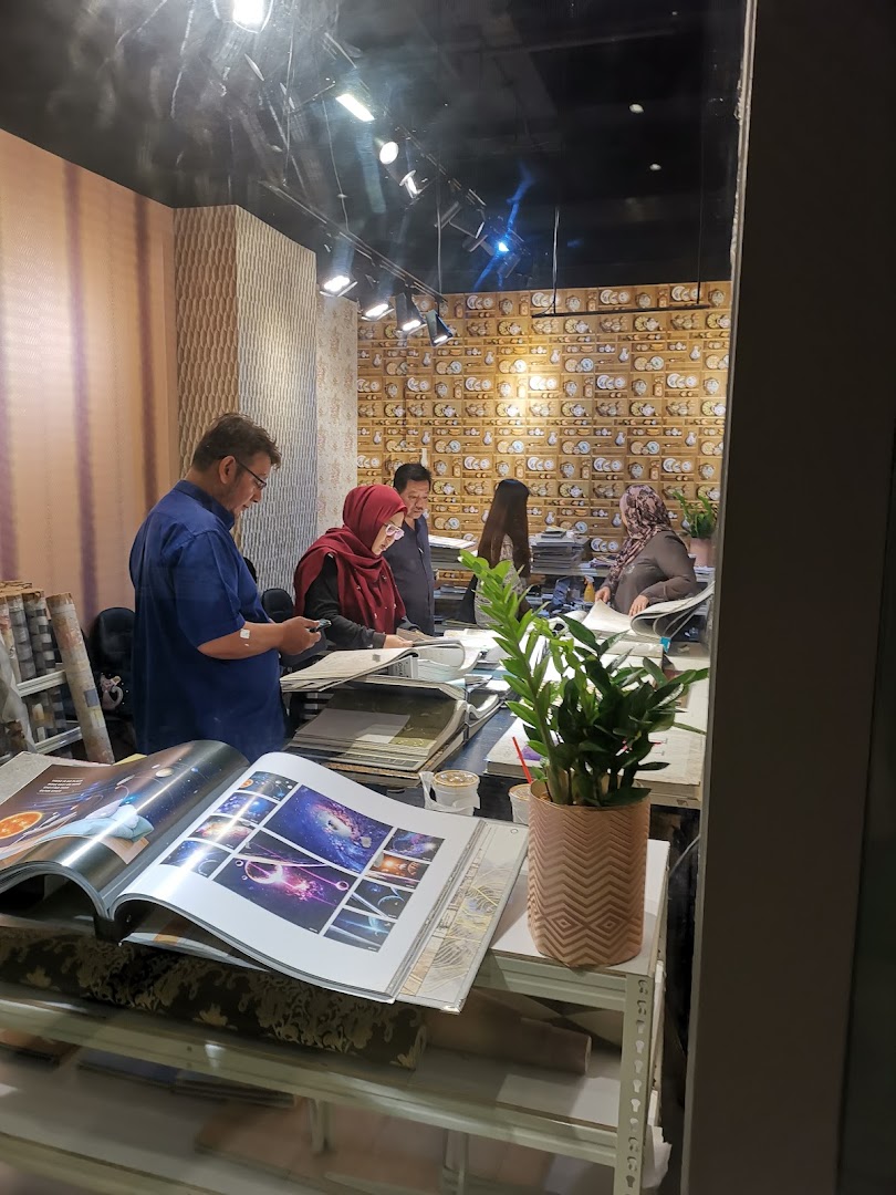 Customers and staff browse design catalogs and samples inside The Catalogue Wallpaper Curtains Gallery.