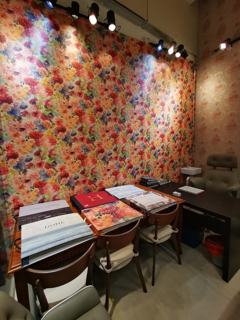 Interior view of 'The Catalogue' shop, showcasing vibrant wallpaper samples and a consultation desk.