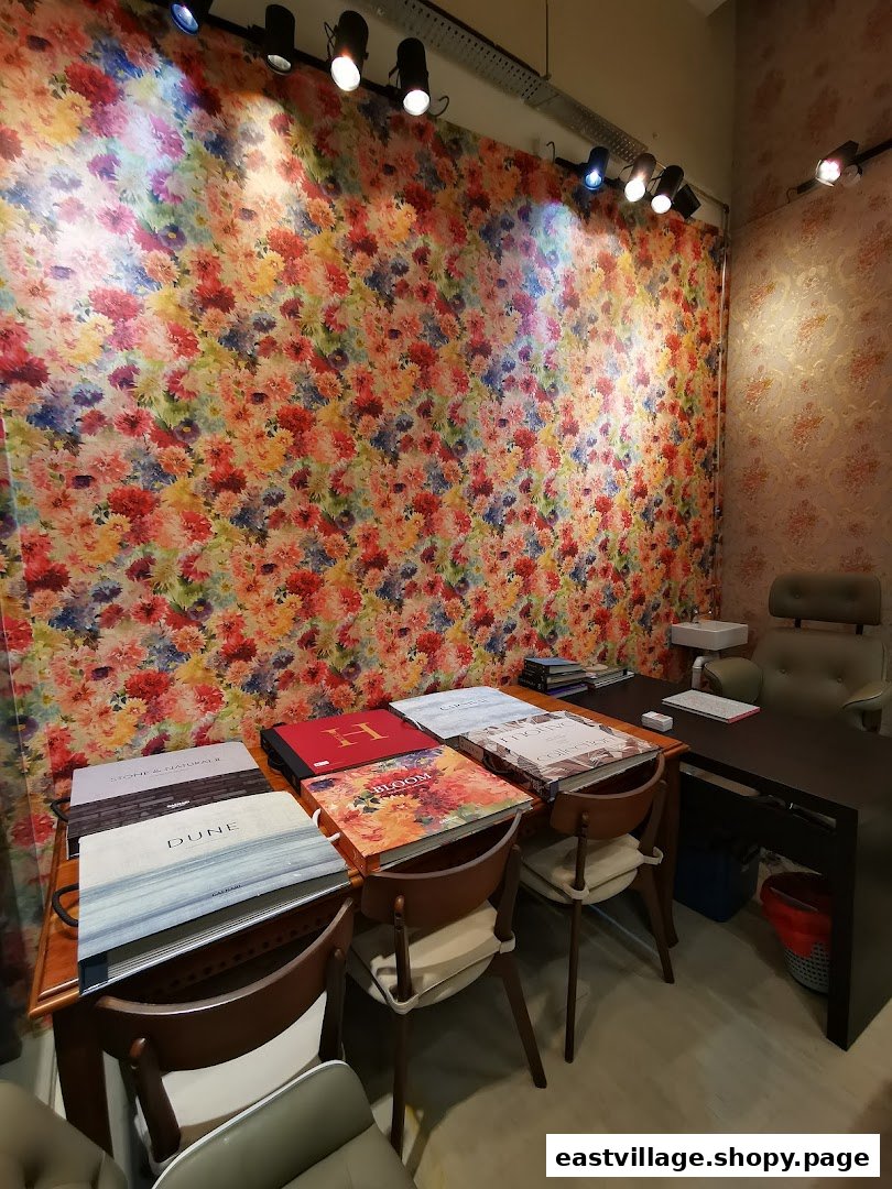 Interior view of 'The Catalogue' shop, showcasing vibrant wallpaper samples and a consultation desk.