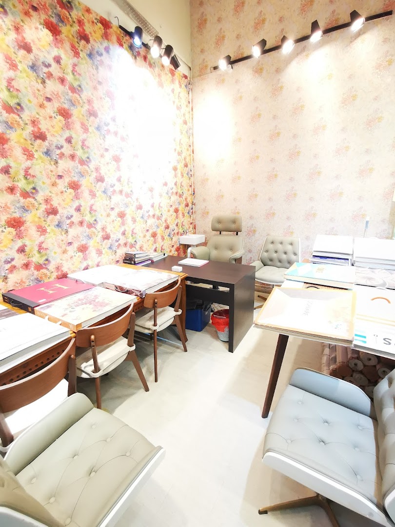 An inviting interior of a wallpaper and curtains gallery, featuring colorful samples and comfortable seating.