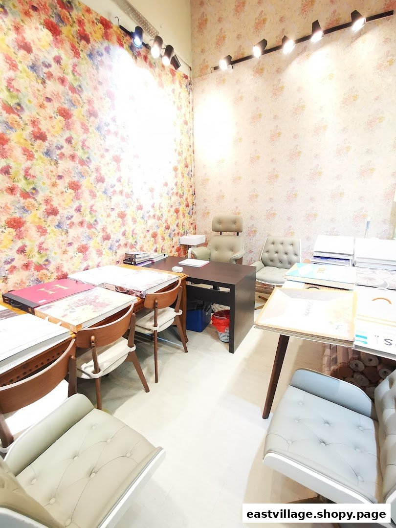 An inviting interior of a wallpaper and curtains gallery, featuring colorful samples and comfortable seating.
