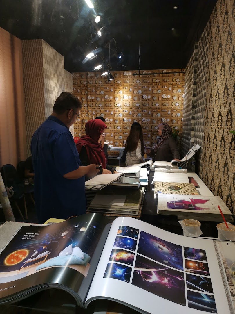 Customers and staff browse wallpaper and curtain design catalogs inside The Catalogue Gallery.