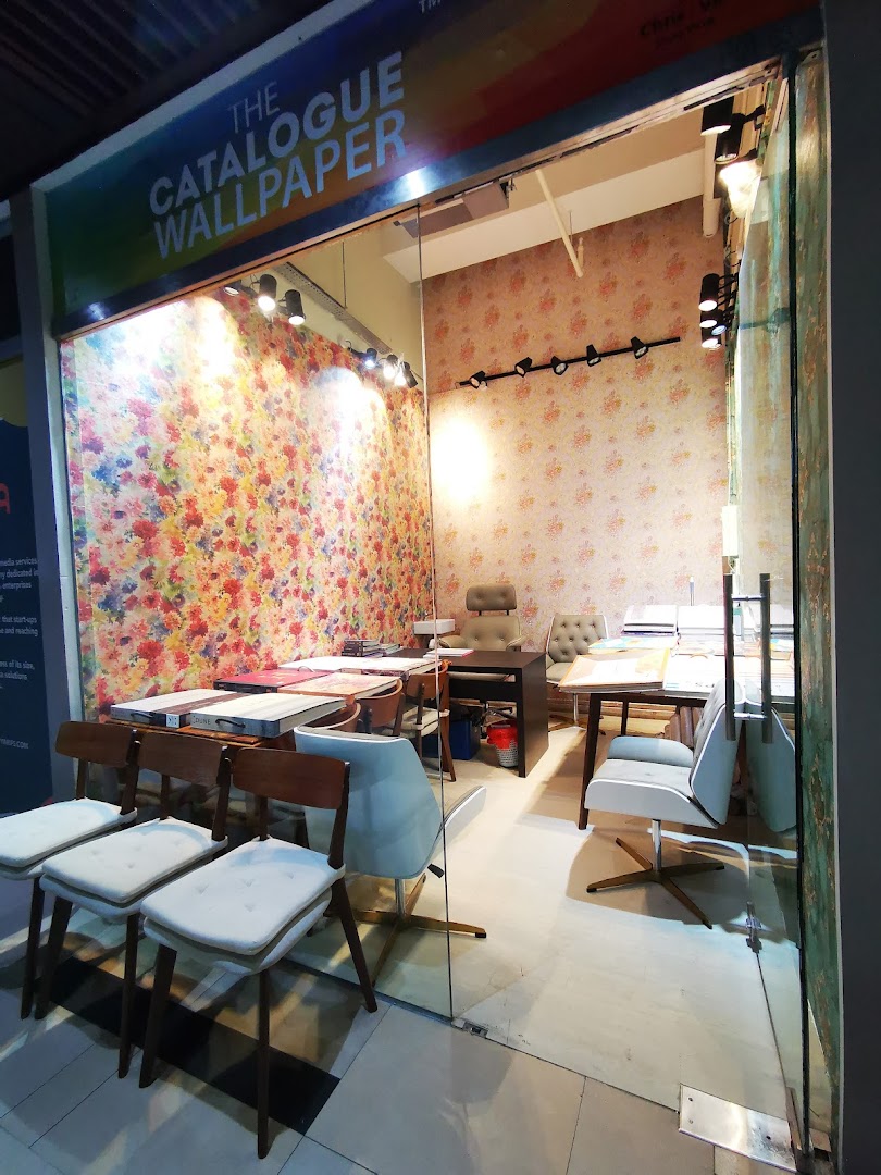 Interior view of The Catalogue Wallpaper Curtains Gallery, showcasing vibrant wallpaper designs and consultation areas.