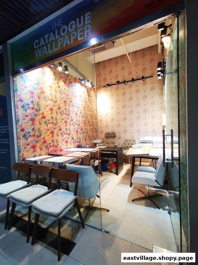 Interior view of The Catalogue Wallpaper Curtains Gallery, showcasing vibrant wallpaper designs and consultation areas.