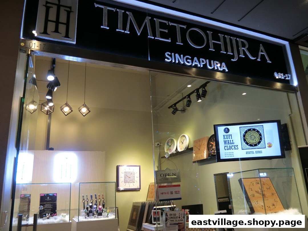 The shopfront of Time To Hijra Singapura, showcasing unique wall clocks and watches in display cases.