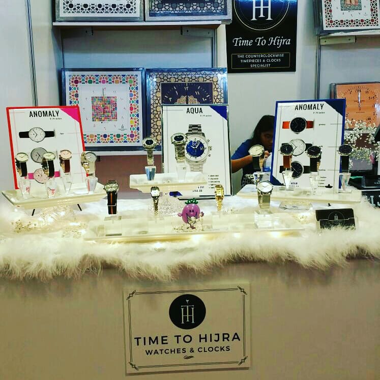 A vibrant display of unique counterclockwise watches and clocks from Time To Hijra.