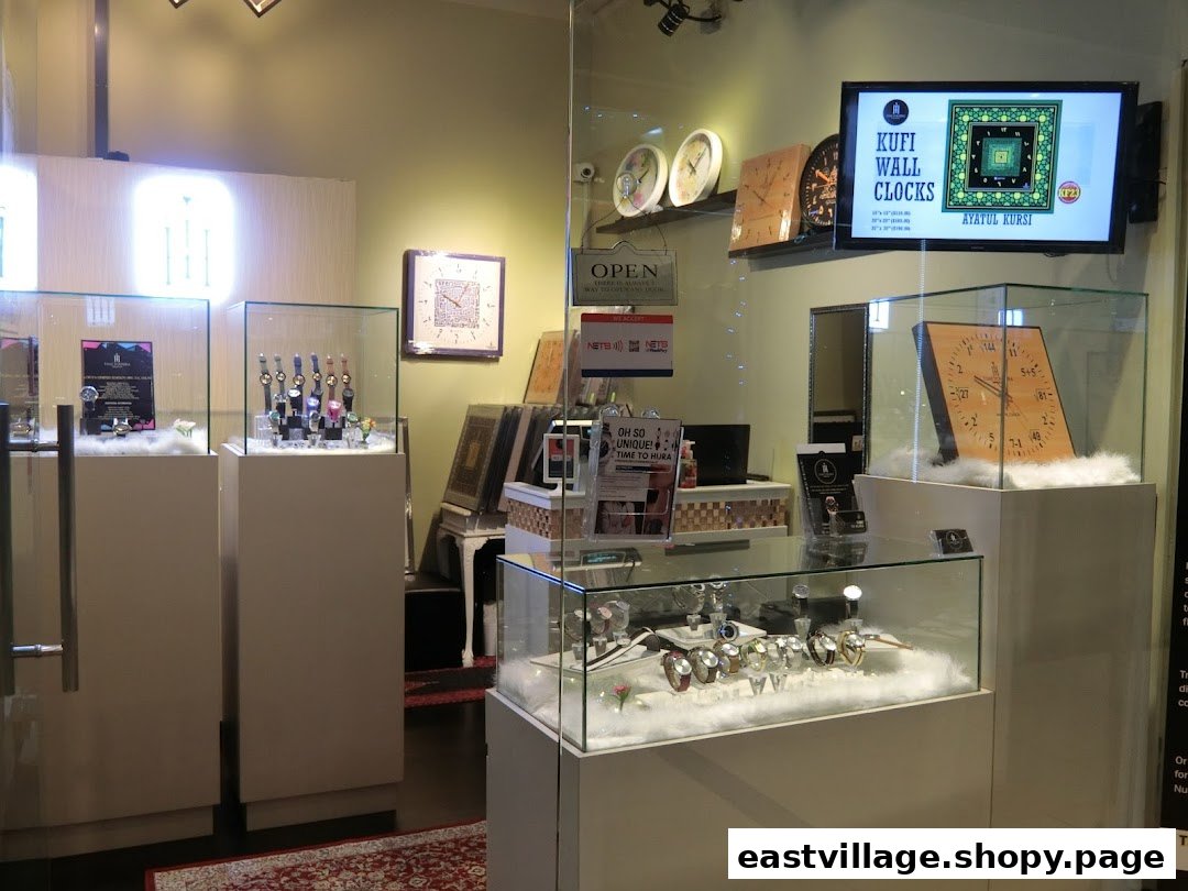 Interior view of Time To Hijra, showcasing display cases with watches and unique Kufi wall clocks.