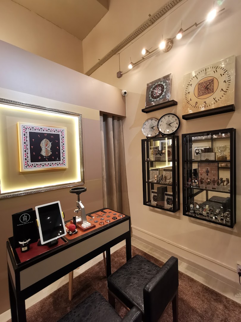 Interior view of Time To Hijra, showcasing watches, Islamic art, and a dedicated display counter.