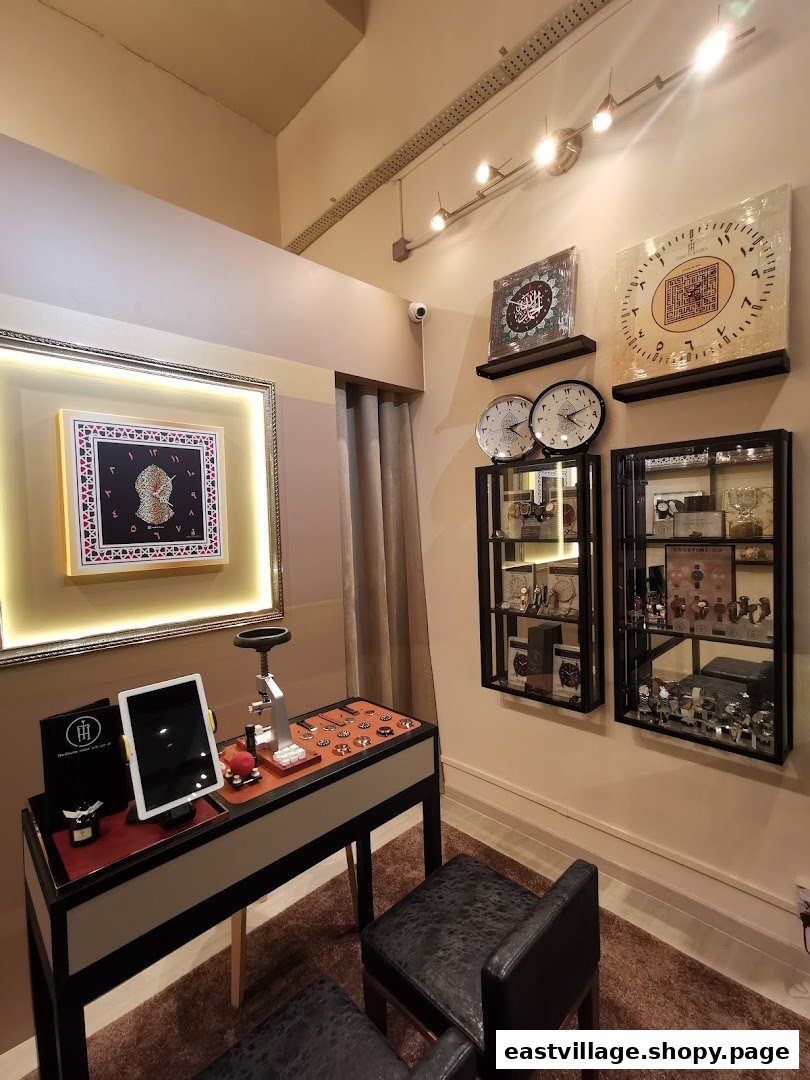 Interior view of Time To Hijra, showcasing watches, Islamic art, and a dedicated display counter.