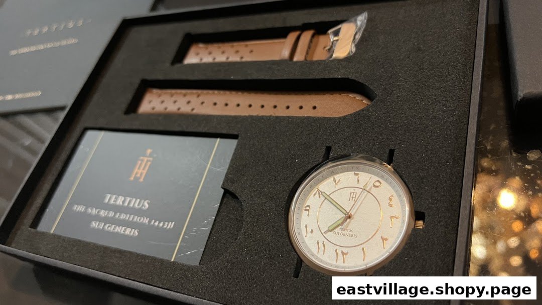 A close-up of a 'Tertius' watch with Arabic numerals and brown leather straps in its presentation box.